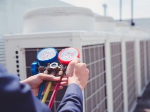 Technician is checking air conditioner ,measuring equipment for filling air conditioners.