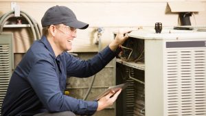 Repairmen works on a home's air conditioner unit.