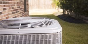 Air conditioner unit outside residential home. Summer
