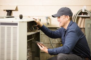 Technician working on a central air conditioning unit